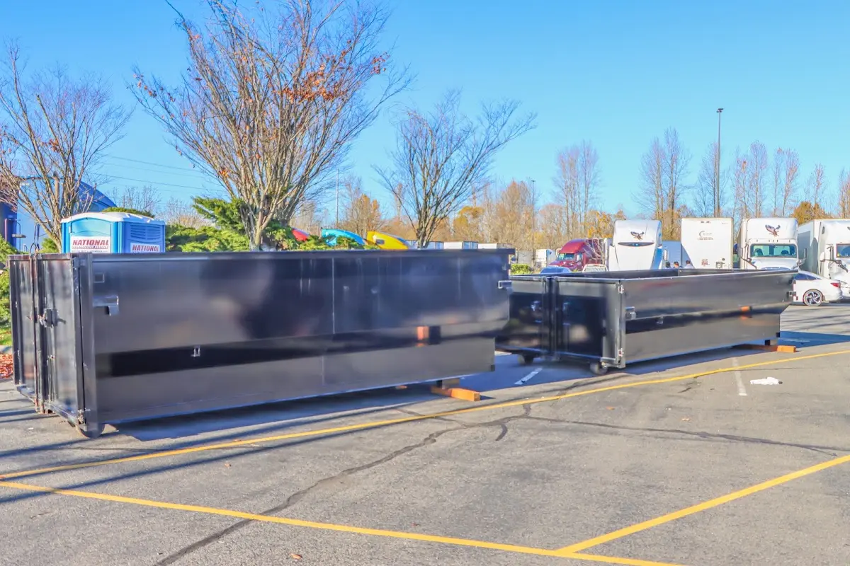 Professional dumpster rental service with roll-off container on residential driveway in Delano